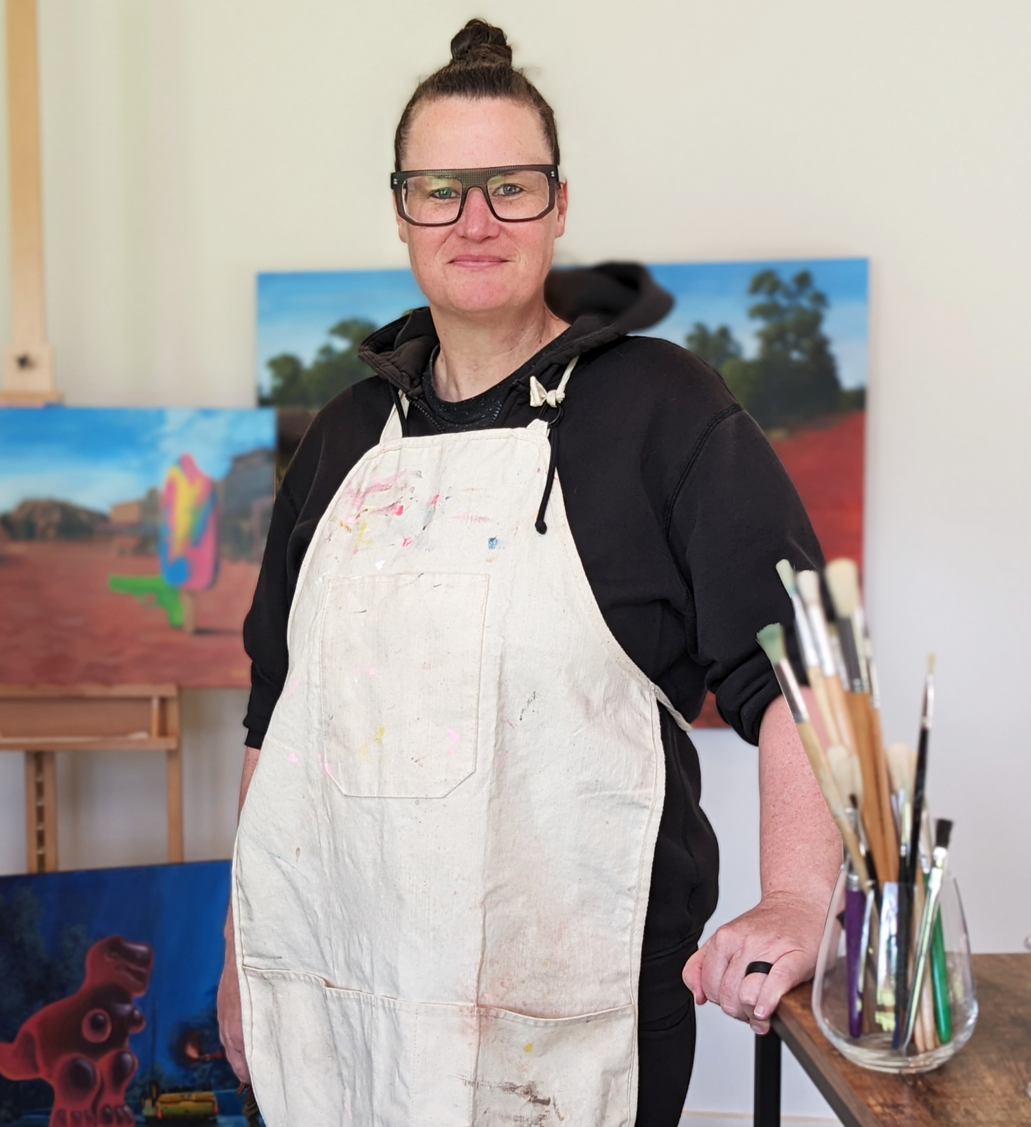 Sally Hastings the artist standing in her studio