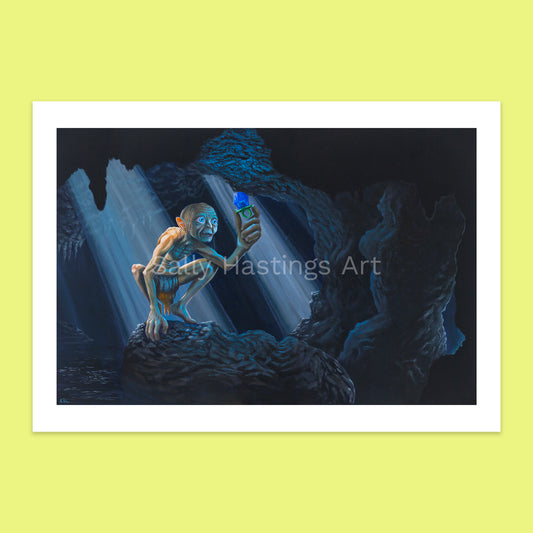 Gollum the creature from Lord of the Rings holding a bright blue ring pop in  dark cave. Limited edition print signed by Sally Hastings